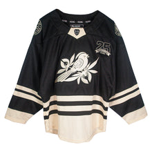 Load image into Gallery viewer, A black and beige hockey jersey by Bayside features a large bird on a branch graphic on the front, &quot;25 Years Strong&quot; with the number 25 on the chest, and striped accents on the sleeves and bottom.