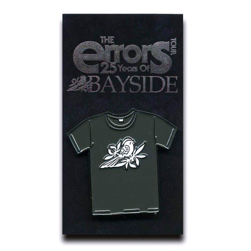 A black enamel Bayside Errors Tour Pin shaped like a t-shirt with a bird and branch design, displayed on a card reading 