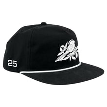 Load image into Gallery viewer, Bayside Atonal Rope Snapback: Black embroidered snapback with a white bird and branch graphic, a white &quot;25&quot; on the side, and a thin white rope trim along the brim for classic style.