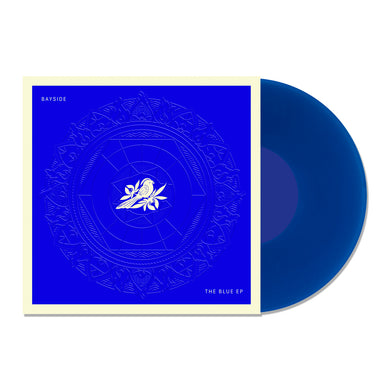 A transparent blue vinyl record slides out of a deep blue, white-bordered cover featuring a white rose and intricate circles. Text on the square sleeve reads 