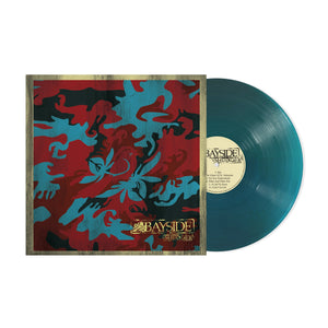 A teal vinyl record partially slides from its sleeve, which features a red, teal, and black abstract floral design. The cream center label displays the brand name Bayside.