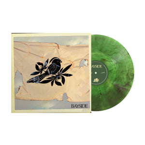 A green marbled vinyl record by Bayside rests near its album cover, which displays an illustrated black bird with floral accents on weathered cloth beneath a cloudy sky. The Walking Wounded tracklist appears at the bottom.