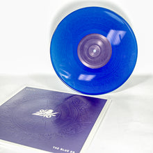 Load image into Gallery viewer, A translucent blue Bayside EP stands upright beside its matching album cover, which features an intricate embossed pattern and a central white lotus design.