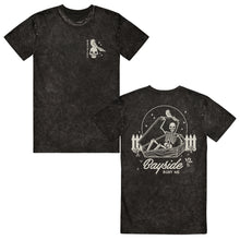 Load image into Gallery viewer, image of the front and back of a black mineral wash tee shirt on a white background. front of the tee is on the left and has a small chest print in white of a skull head and a bird. vertically on the left says bayside. the back of the tee is on the right and has a back print in white of a skeleton opening up a coffin. below that says bayside bury me