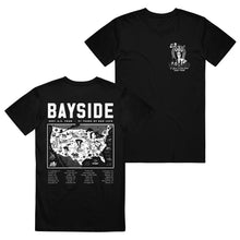 Load image into Gallery viewer, image of the front and back of a black tee shirt on a white background. the back of the tee is on the left and has a full back print on white that says bayside on the top, a map of the USA in the middle and tour dates below. the front of the t is on the right has a small chest print on the right of a woman holding a flag and says bayside all in white print.