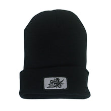 Load image into Gallery viewer, image of a black winter beanie on a white background. beanie has sewn on rectangle patch on the front cuff. patch is grey with a bird in black