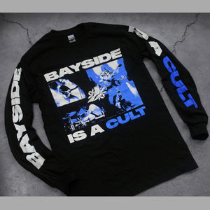 angled image of a black long sleeve tee shirt on a concrete background. tee has full center chest print in blue and white of a collage of four images of the band playing on stage. above the image says bayside, and below says is a cult. the left sleeve says bayside, and the right sleeve says is a cult