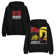 Load image into Gallery viewer, image of the front and back of a black pullover hoodie on a white background. front of the hoodie is on the left and has a red print that says bayside. below is a black and white rectangle image of a bird on water. the back of the hoodie is on the right and has a full print of a hand coming out of water, bayside, a bird and the words to drown in the ocean with you.