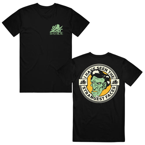 image of the front and back of a black tee shirt on a white background. front of the tee is on the right and has a small chest print on the right in green of a bird and below the bird says bayside. the back of the tee is on the right and has a print of a green, zombie face. around the face says i have seen the strangest faces